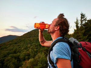 A hiker drinking water